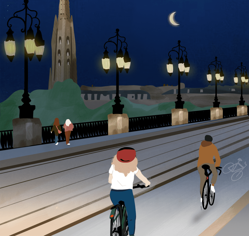 2 personnes qui se baladent sur une piste cyclable, la nuit, sur le pont de pierre à Bordeaux